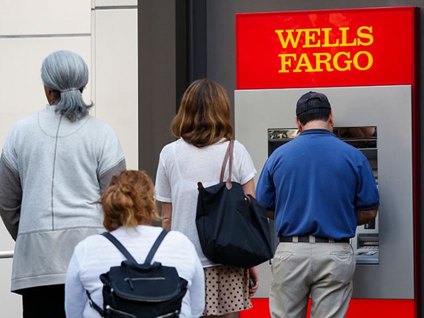 Customers wait in line for an ATM outside of a Wells Fargo & Co. bank branch in Los Angele