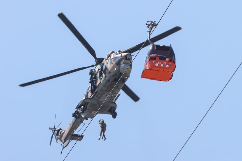 ANTALYA, TURKIYE - APRIL 13: A member of Coast Guard Command participates in evacuation work for the cabins suspended in the air after a cable car cabin crashed into a fallen cable car pole at the Tunektepe Cable Car Facility, Konyaalti district in Antalya, Turkiye on April 13, 2024. Authorities have successfully rescued 128 stranded people after a cable car accident in the southern Turkish province of Antalya. Four helicopters under the Coast Guard Command played an active role in the rescue operation. (Photo by Orhan Cicek/Anadolu via Getty Images)