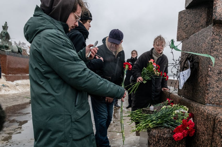 ST PETERSBURG, RUSSIA - 2024/02/17: People gather at a monument to victims of political repression to honor the memory of Russian opposition leader Alexei Navalny a day after news of his death, in St. Petersburg. (Photo by Andrei Bok/SOPA Images/LightRocket via Getty Images)