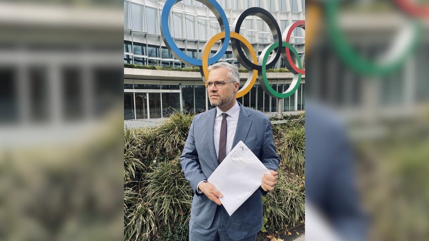 Dr. Felix Böllmann, director of European advocacy for ADF International, delivering the petition to the International Olympic Committee in Lausanne.