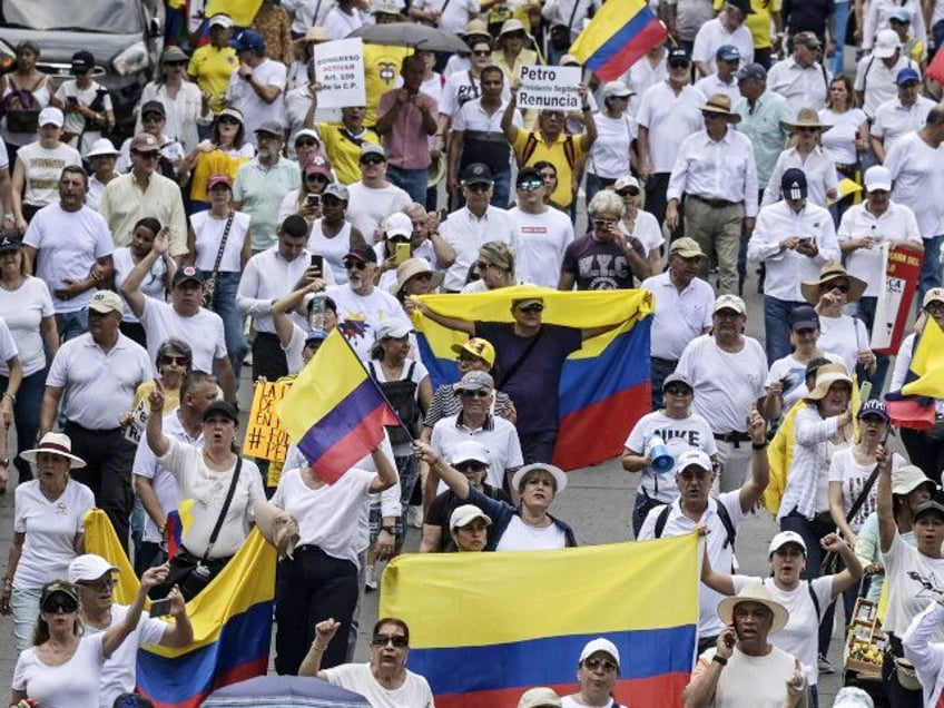 Demonstrators march against the government of Colombian President Gustavo Petro over healt