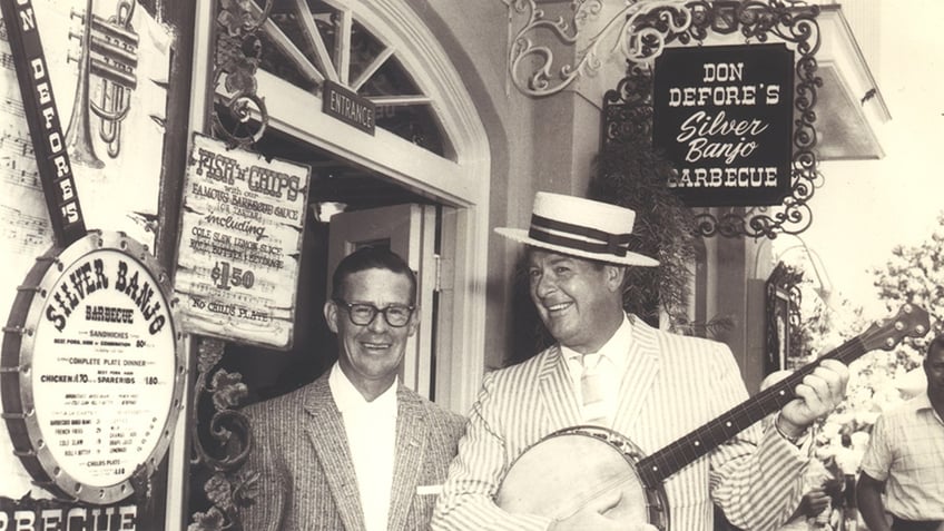 Don DeFore playing a banjo.