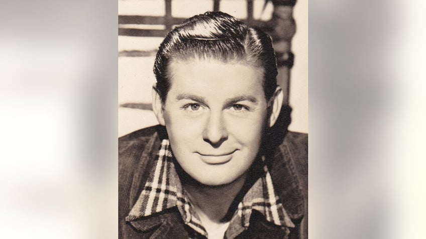 A close-up of Don DeFore in a plaid shirt and a jean jacket.