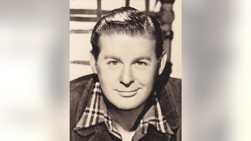 A close-up of Don DeFore in a plaid shirt and a jean jacket.