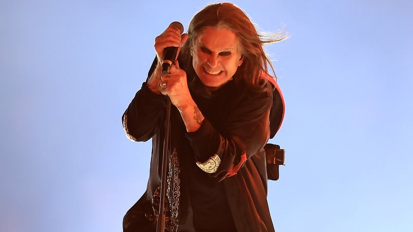 Ozzy Osbourne onstage holding mic