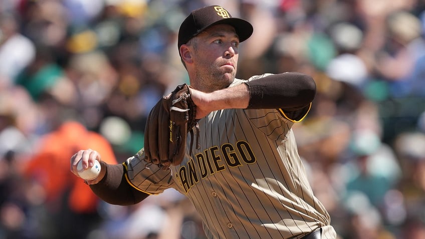 Jason Adam throws a pitch