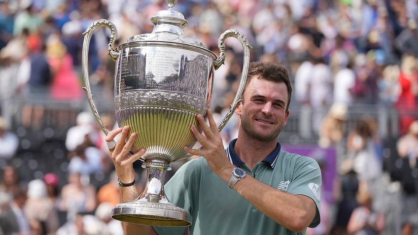 Tommy Paul holds the trophy