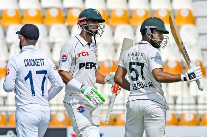 Pakistan's Abdullah Shafique (right) celebrates reaching fifty with with captain Shan Maso