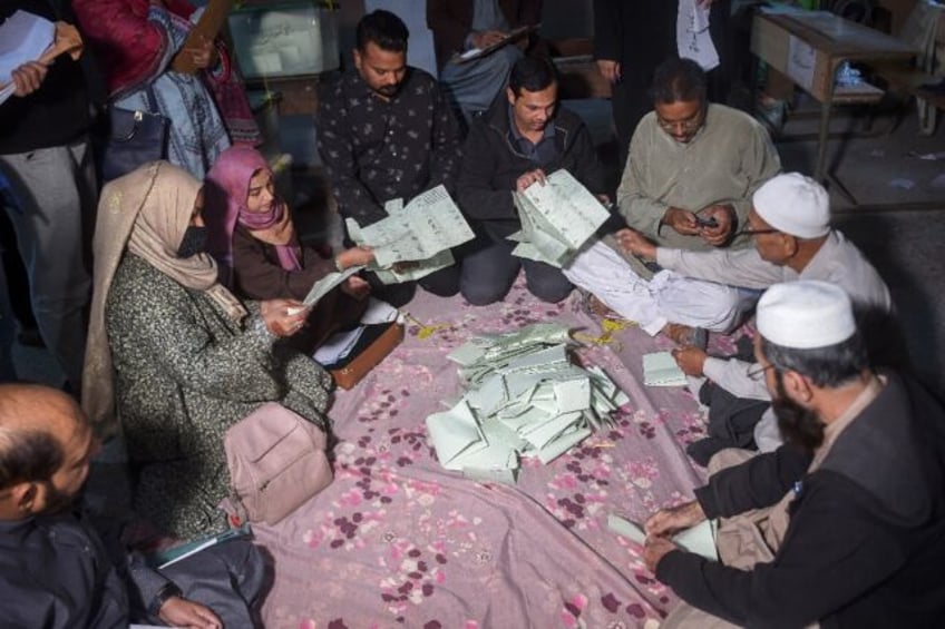 Election officials in Karachi count votes after polls end during the Pakistan's national e