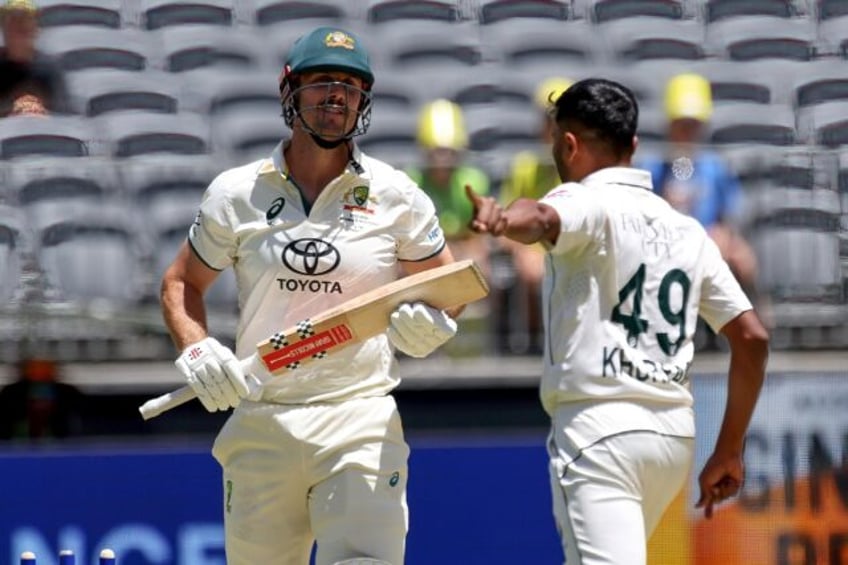 Australia's Mitchell Marsh (L) was bowled by Pakistan's Khurram Shahzad (R) for 90