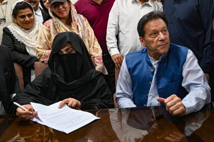 Former Pakistani prime minister Imran Khan (R) and his wife Bushra Bibi (L) have been sentenced to 14 years in jail for graft