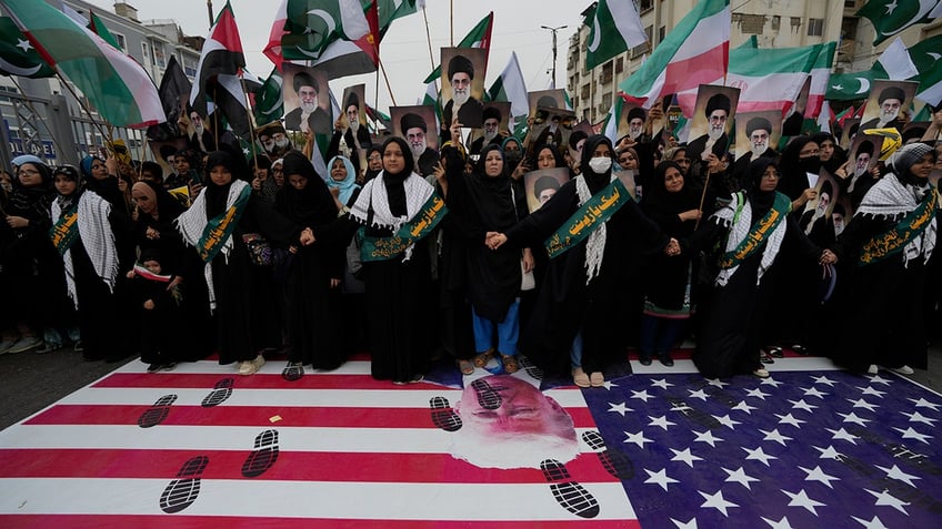 Pakistan demonstration with footprints on the American flag