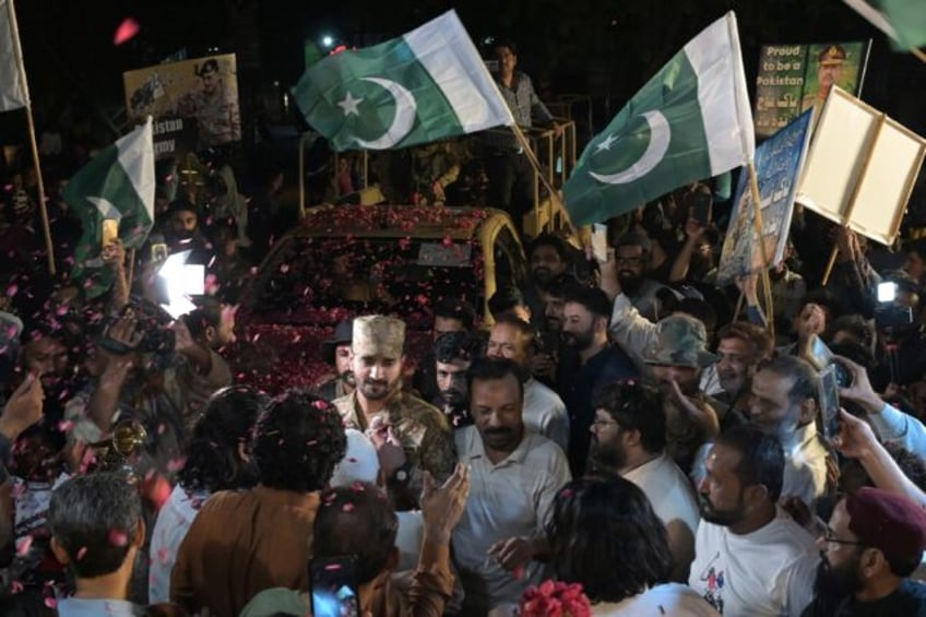 People throw rose petals at army personnel to express solidarity with Pakistan's armed for