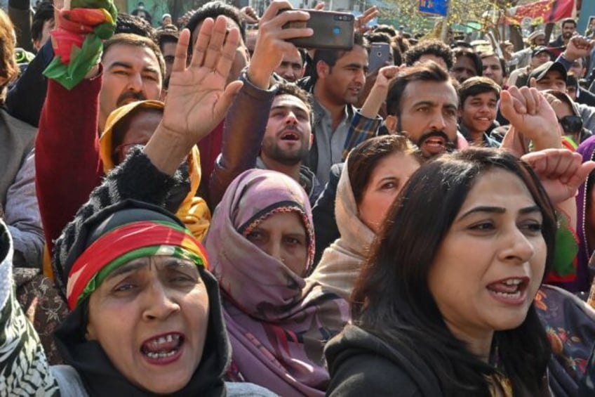 Supporters of Imran Khan's Pakistan Tehreek-e-Insaf (PTI) party shout slogans in an electi