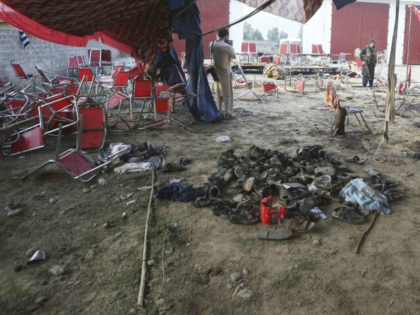 Shoes of victims are gathered after of Sunday's suicide bomber attack, in the Bajur d