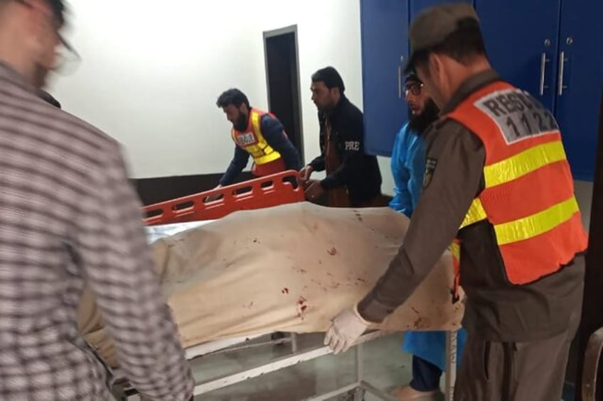 Rescue staff carry the bodies of victims of a roadside bomb blast in Bajaur district, northwest Pakistan, in a handout picture from provincial authorities