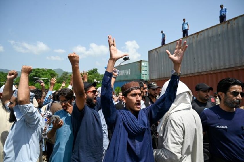 Supporters of the Tehreek-e-Labbaik Pakistan (TLP) party shout slogans as they protest aga