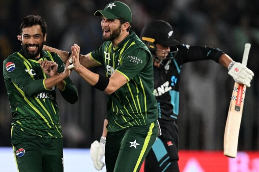 Pakistan's Mohammad Amir (L) celebrates with teammate Shaheen Shah Afridi after taking the