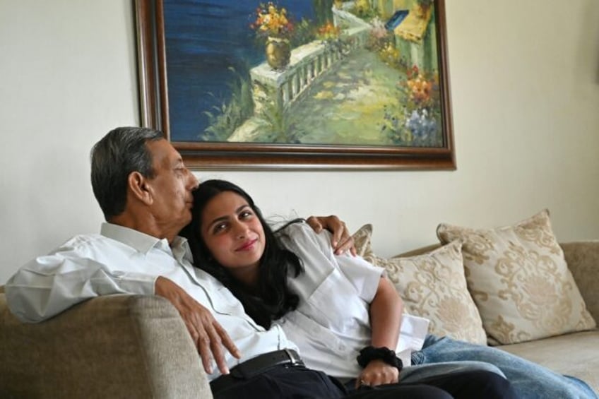 In this photograph taken on February 28, 2025, Kersi Umrigar (L), a 76-year-old, embraces