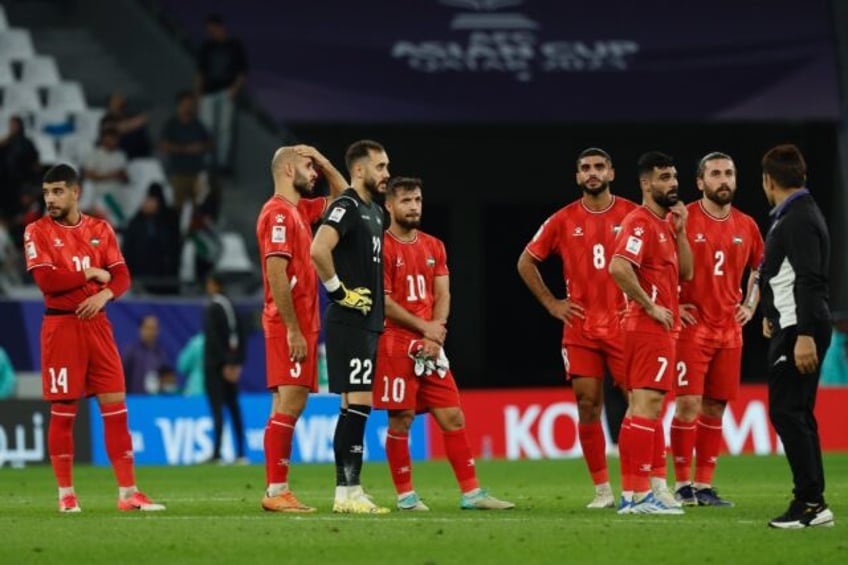 Palestine's players after their heavy defeat to Iran