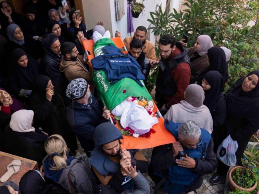 Relatives mourn as the body of Palestinian Shatha al-Sabbagh, a 22-year-old journalism stu