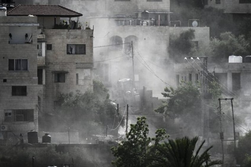 Smoke billowed over the refugee camp in Jenin after an Israeli raid killed at least seven