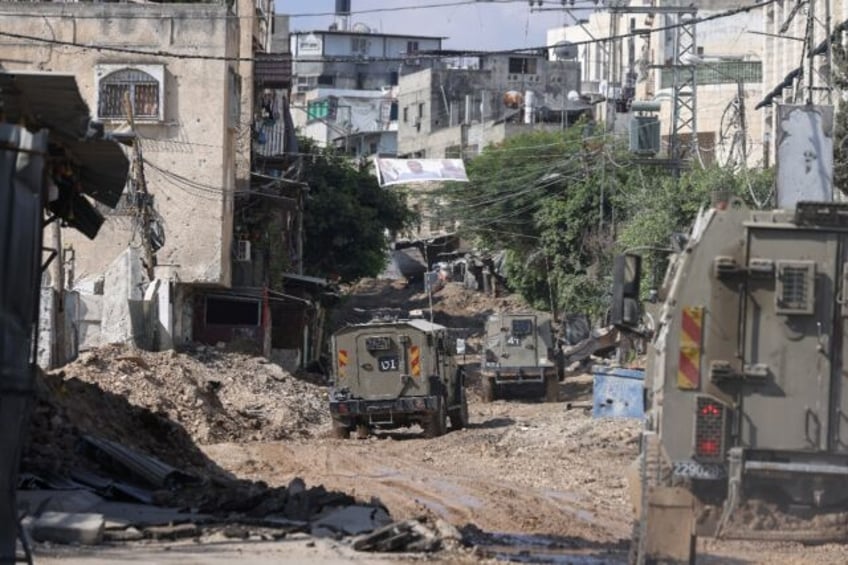 A column of Israeli military vehicles enters Tulkarem refugee camp in the occupied West Ba