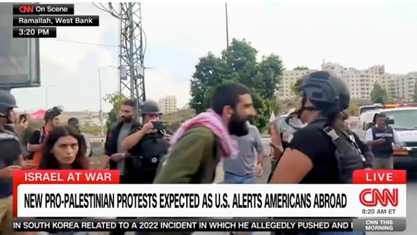 palestinian protesters scream at cnn reporter in west bank security escorts her away