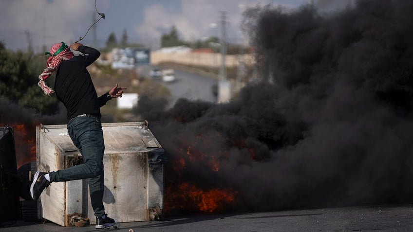 palestinian protesters scream at cnn reporter in west bank security escorts her away