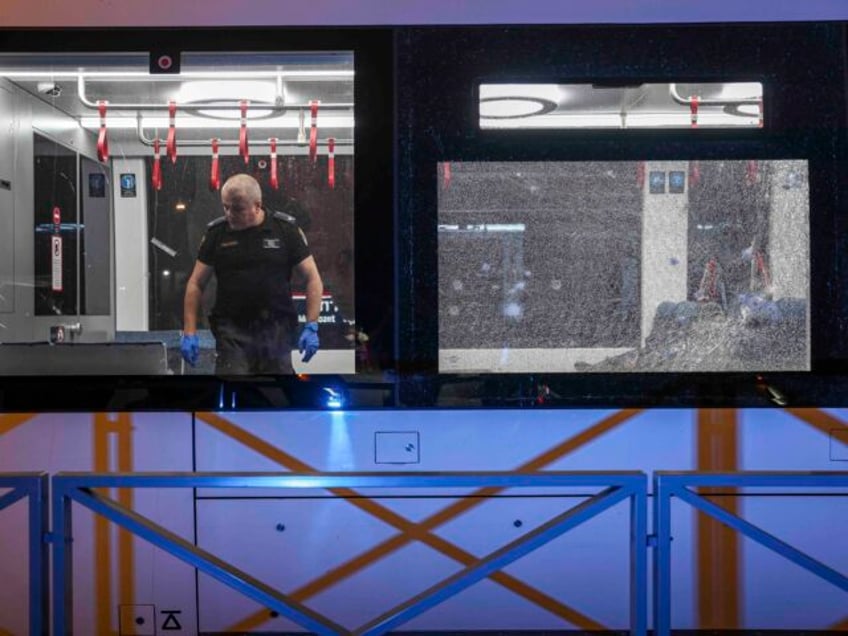 An Israeli forensic technicians work in a light rail car following a shooting attack in Ja