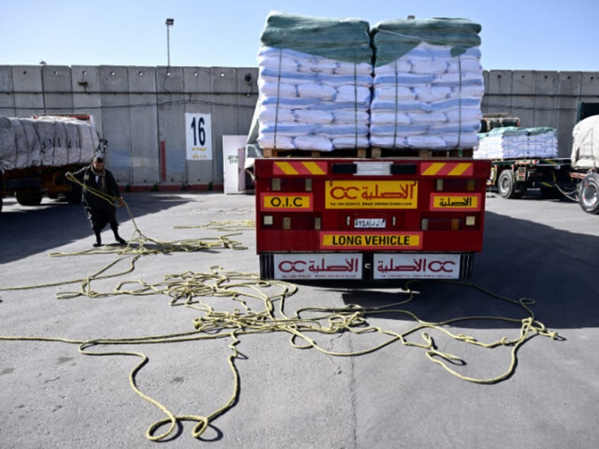 A truck driver re-loads his humanitarian aid cargo after inspection by Israeli security upon arriving from Egypt on the Israeli side of the Kerem Shalom border crossing with the southern Gaza Strip on December 22, 2023, amid the ongoing conflict between Israel and the Palestinian militant group Hamas. (Photo by …