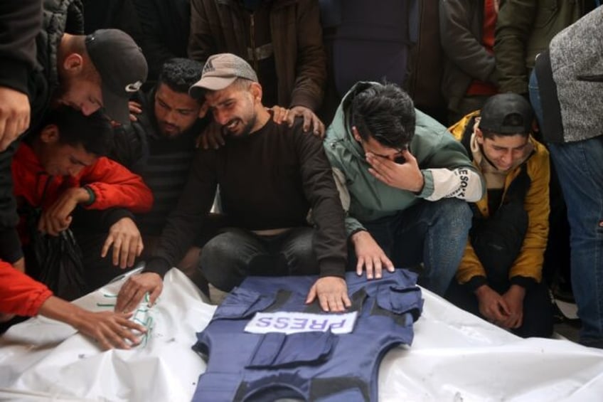 Mourners at the funeral of Al-Quds Today journalists killed in a strike in central Gaza, w