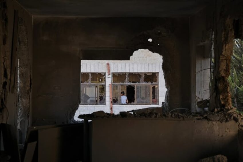 Palestinians inspect the damage after Israeli troops demolish the home of detained suspect