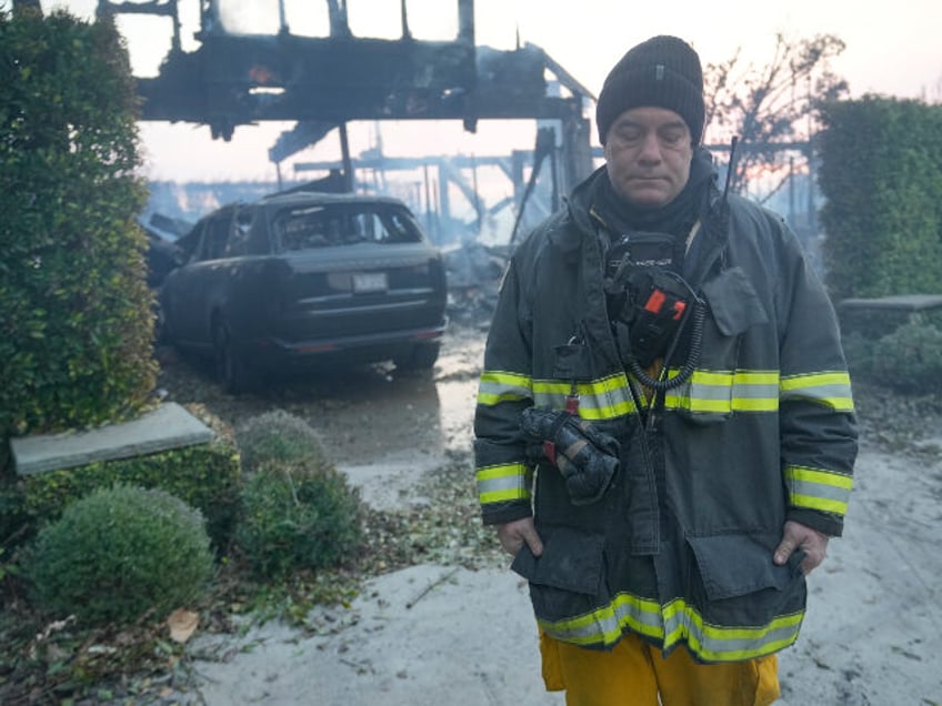 Gilroy Fire Department's Firefighter/Paramedic Kevin Bebee walks away after mopping u