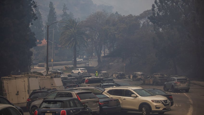 Cars littered the road amid the Palisades Fire.