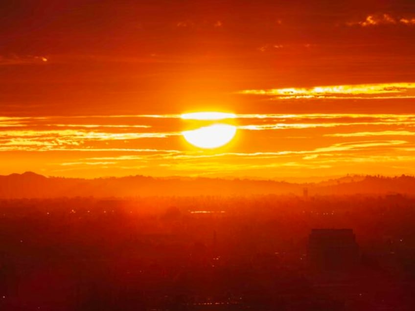 Los Angeles fiery morning sun bursting through clouds and fog above the San Fernando Valle