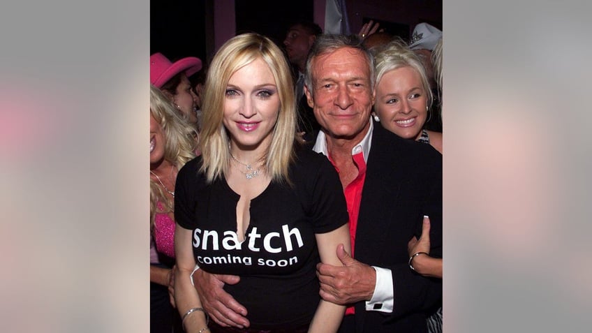 Madonna being held by Hugh Hefner