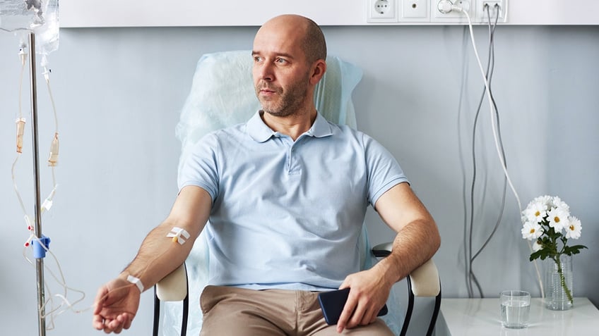 man sitting in comfortable chair with IV drip