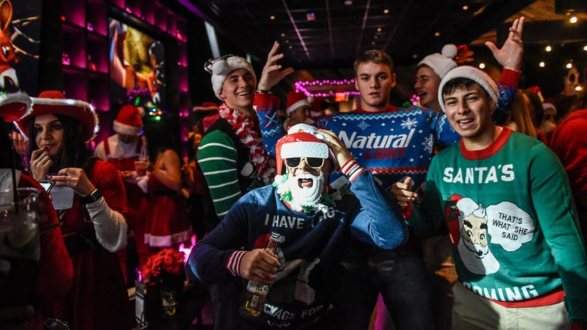 santacon participants at a bar