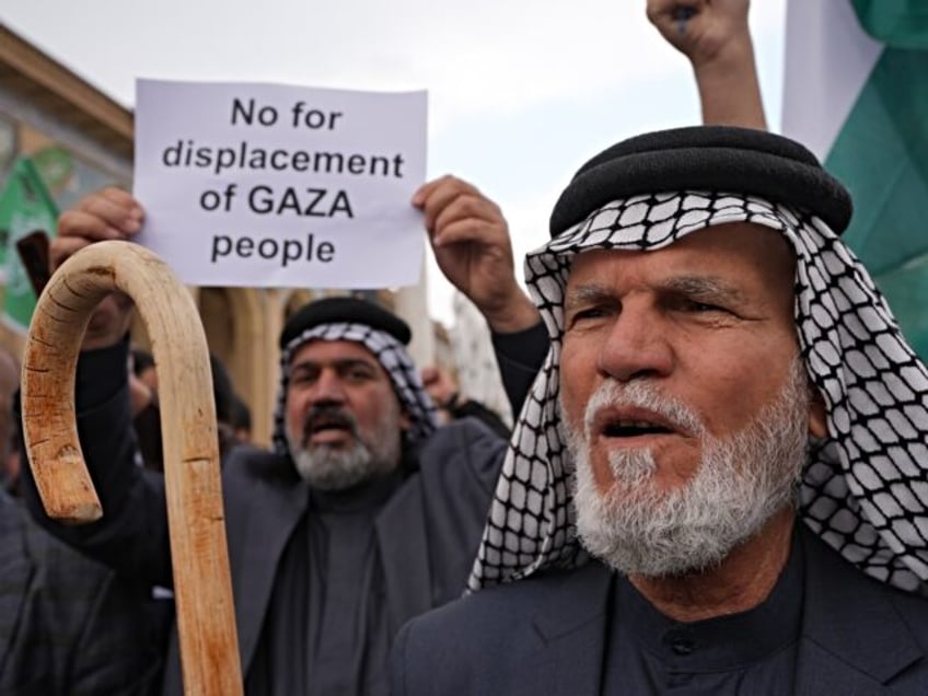 BAGHDAD, IRAQ - FEBRUARY 07: People gather in front of the Imam Azam Mosque holding banner