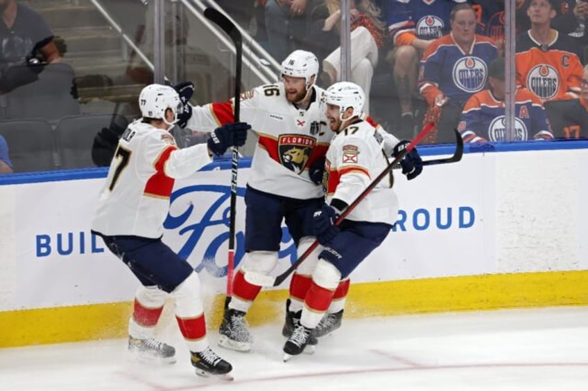 Florida's Aleksander Barkov celebrates with Niko Mikkola and Evan Rodrigues after scoring