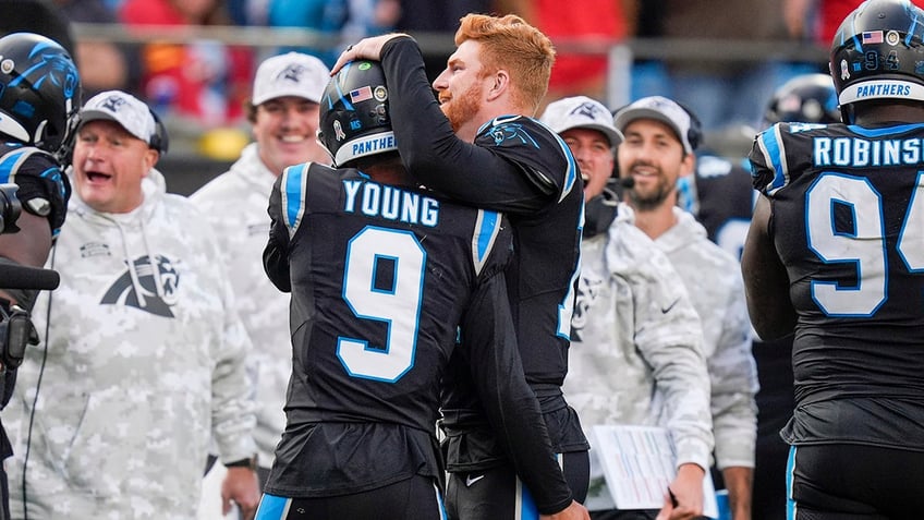 Bryce Young and Andy Dalton embrace