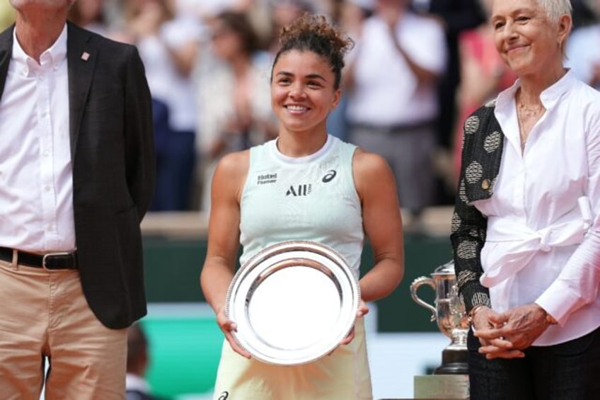 Jasmine Paolini poses with the runner-up trophy after her loss to Iga Swiatek in the Frenc