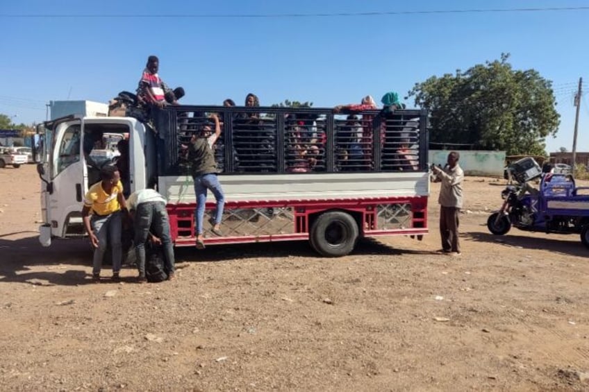 Displaced people fleeing from Wad Madani in Sudan's Al-Jazirah state arrive in Gedaref in the country's east