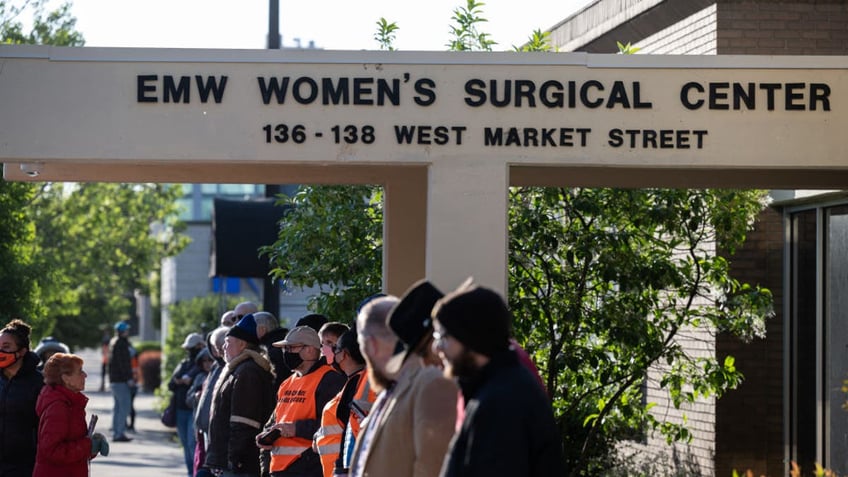 LOUISVILLE, KY - MAY 08: Pro-life demonstrators and clinic escorts stand in front of the EMW Womens Surgical Center, an abortion clinic, on May 8, 2021 in Louisville, Kentucky. Various anti-abortion religious groups and members of pro-life organizations gathered on the sidewalk near the clinic to wish approaching patients a happy Mother's Day and convince them not to enter. (Photo by Jon Cherry/Getty Images)