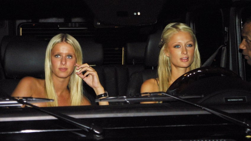 Nicky Hilton and Paris Hilton in a car shot by paparazzi