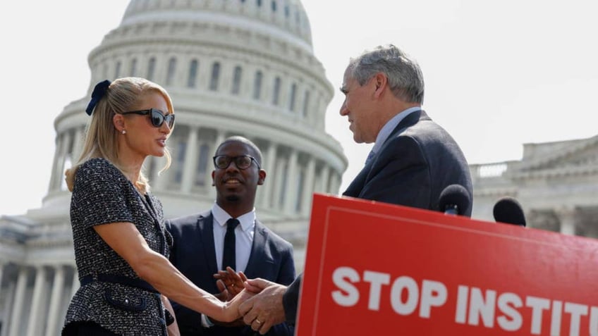 Paris Hilton with Sen. Merkley at press event on Capitol Hill 