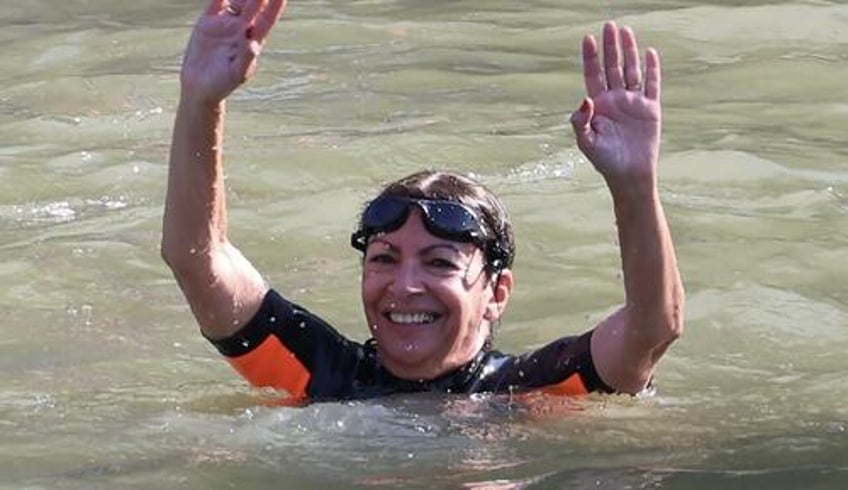 paris mayor defies poop threats to swim the seine river ahead of olympic games