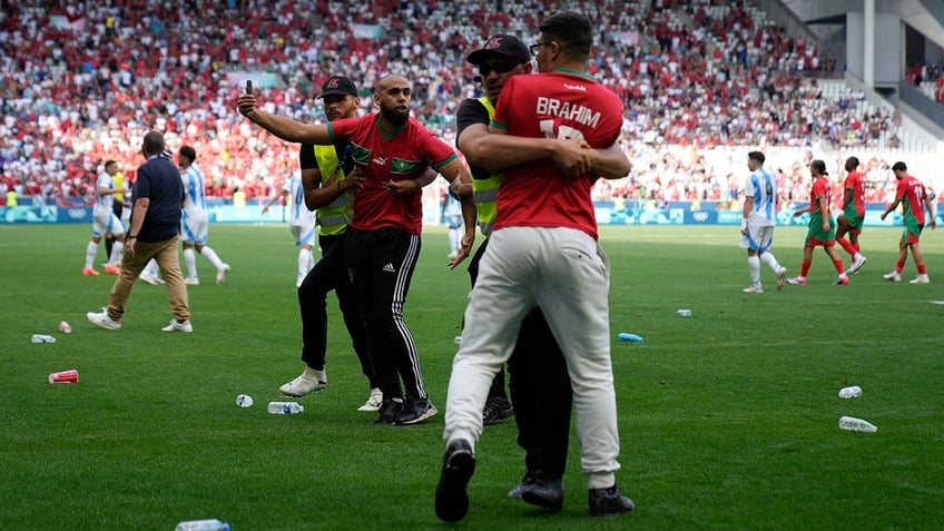 Bottles strewn across the pitch