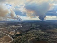 Parts of Canadian city in oil sands region evacuated as wildfire draws near